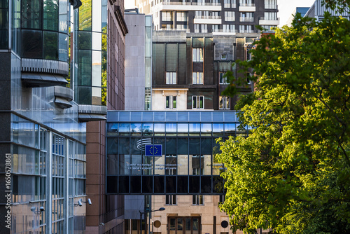 European Economic and Social Committee building in Brussels, Belgium, featuring a glass skybridge with the European Union flag emblem, surrounded by modern office building