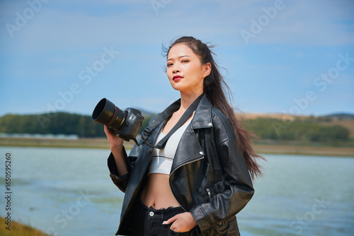 Asian young female photographers shooting outdoors by a lake