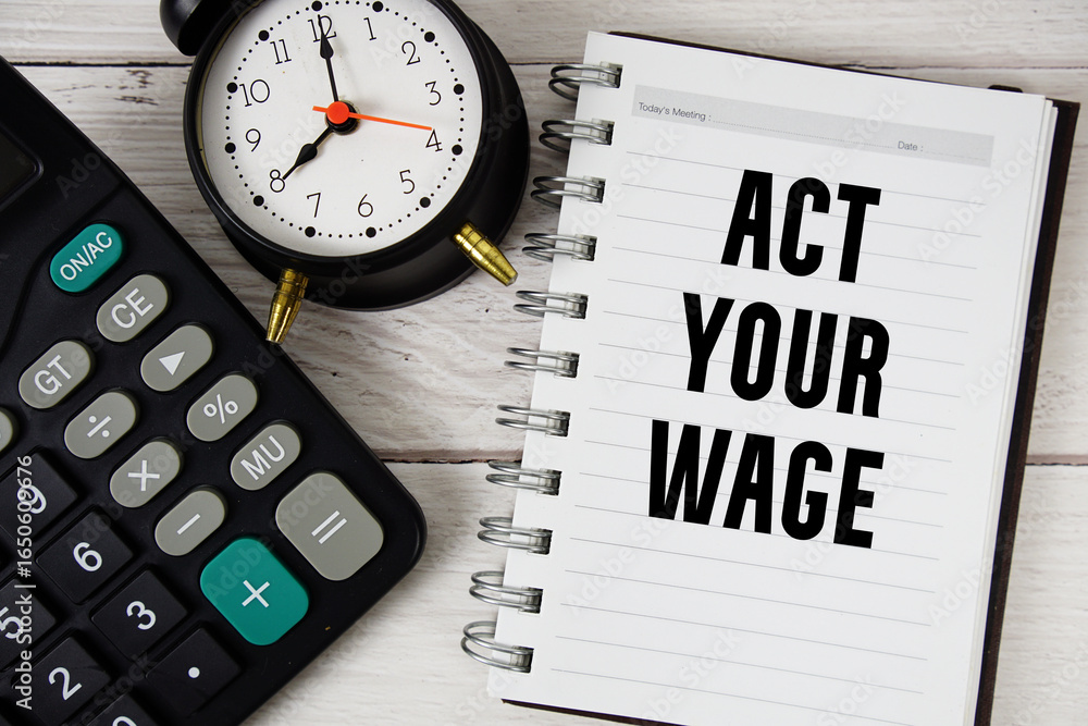 Act Your Wage text with calculator and alarm clock on wooden background Act Your Wage text with calculator and alarm clock on wooden background