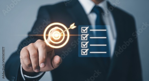 Businessman pointing at a glowing target with an arrow hitting the bullseye, representing business goals and success