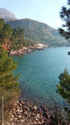 The beauty of the coast in Montenegro: a wild beach on the outskirts of Bar. Nature at the Ratac Monastery: a view of picturesque mountains, a forest with pine trees and a clean sea with blue water