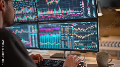 Trading floor setup with multiple computer monitors showing stock market charts and financial data