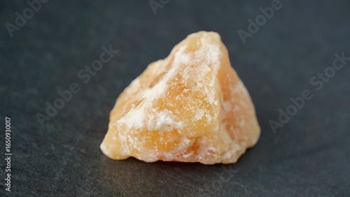 Quadro em tela Orange calcite on dark background. Natural gemstone