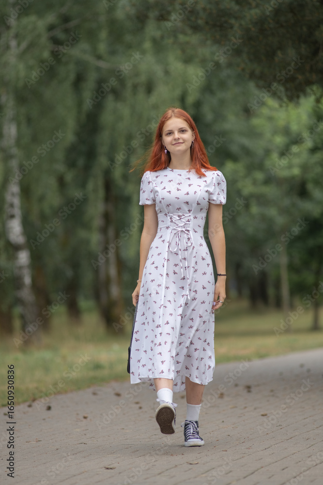 Young beautiful girl in a light dress having fun outdoors on a summer day. Young beautiful girl in a light dress having fun outdoors on a summer day.