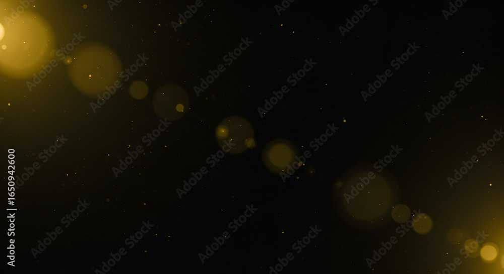 Naklejka premium Golden light leak with shimmering particles overlaying on a black background