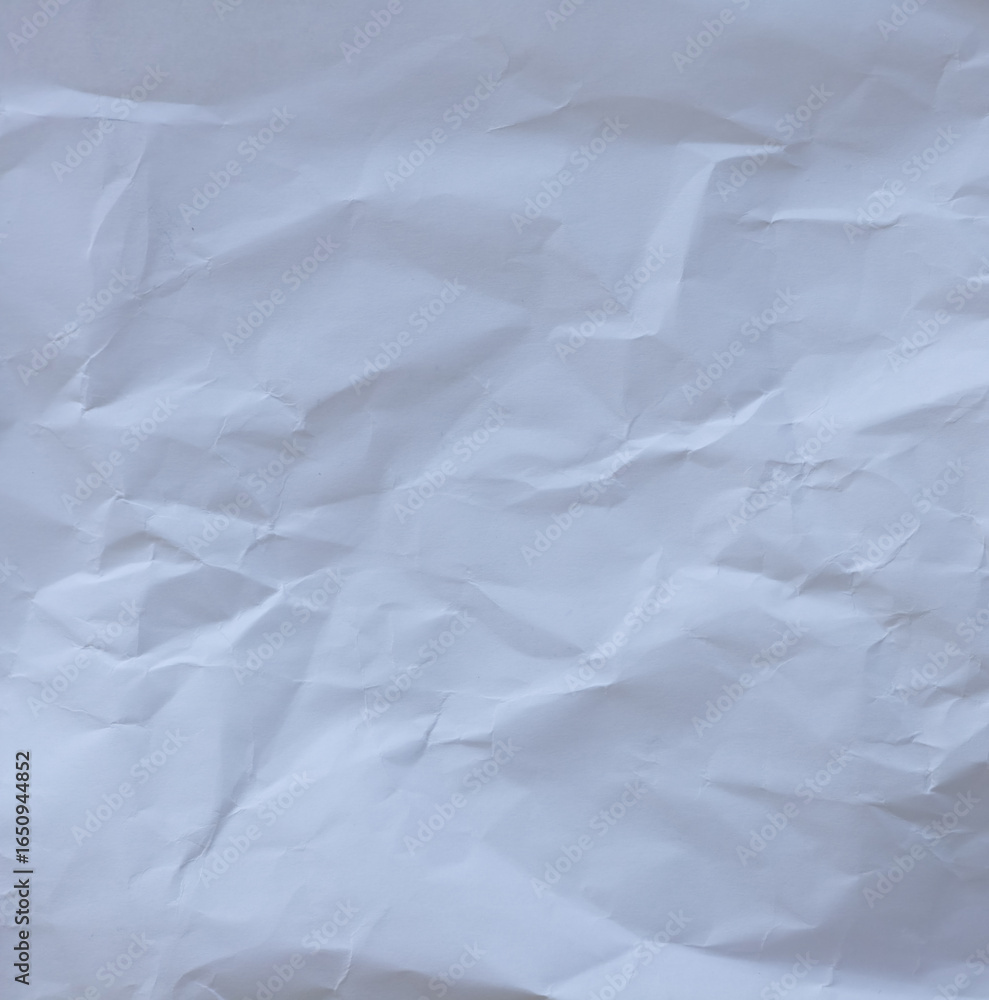 Fototapeta premium Macro texture of wrinkled white paper with natural folds and creases