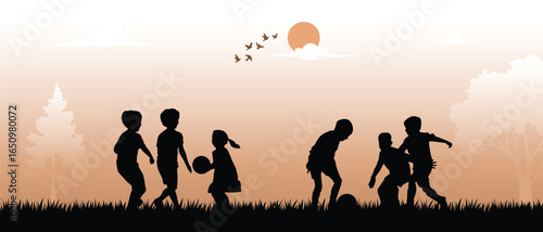 Children playing with ball in park silhouette at sunset