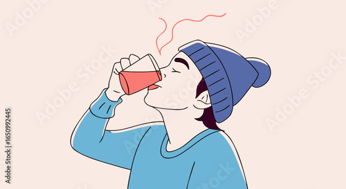 Person enjoying a hot beverage in a cozy winter hat and blue sweater