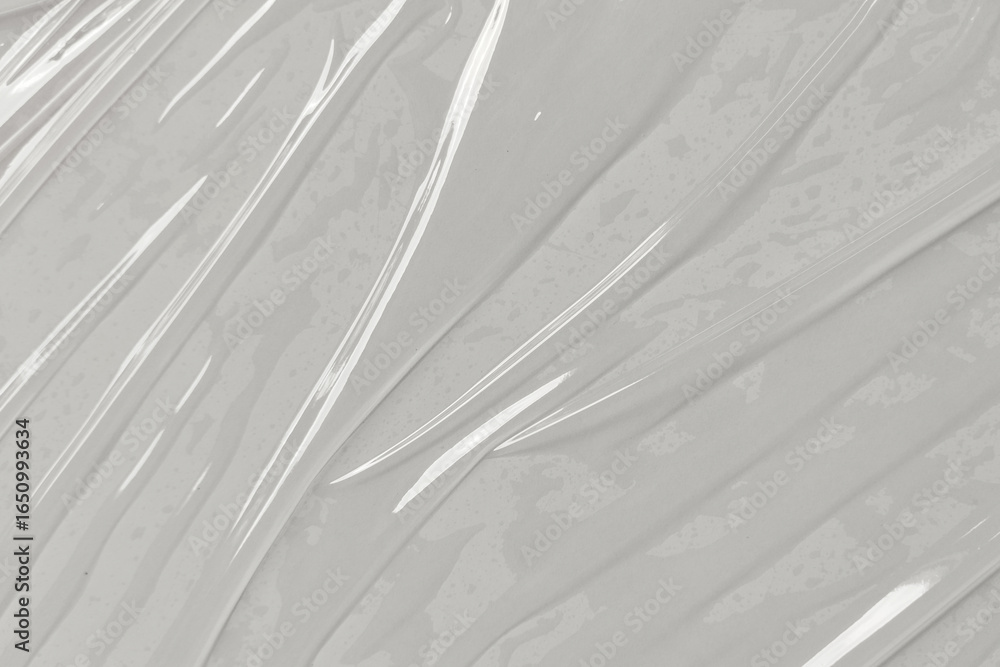 Obraz premium Closeup view of crinkled translucent plastic wrap material suitable for packaging, sustainability, ecofriendly concepts, texture backgrounds, and abstract designs.