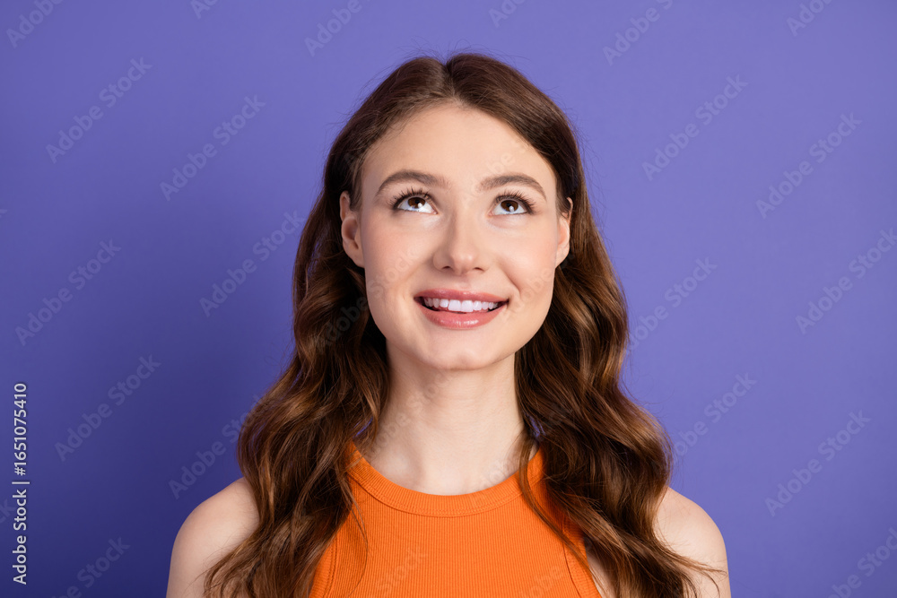 Adorable with a charming smile and orange top against a violet background, expressing happiness and positivity Adorable with a charming smile and orange top against a violet background, expressing happiness and positivity