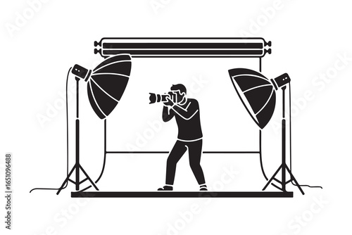 Silhouette of a photographer taking a picture in a studio