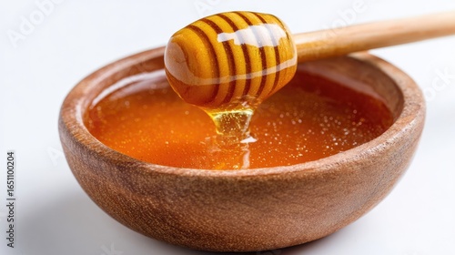 Honey pot and dipper on white background.