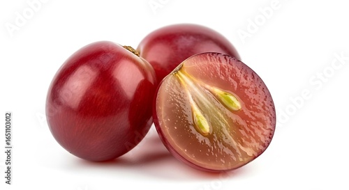 Fresh ripe red grapes one cut open showing seeds and pulp