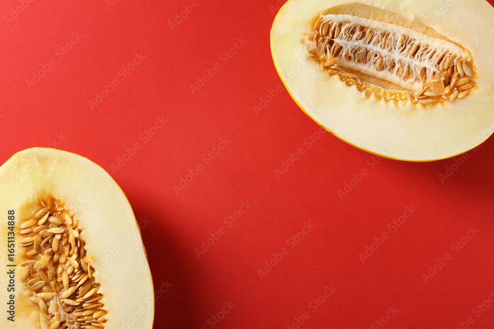 Halves of ripe melon on red background, flat lay. Space for text Halves of ripe melon on red background, flat lay. Space for text
