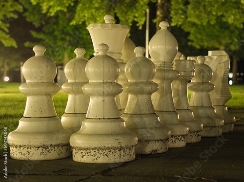 Outdoor White Chess Pieces at Night