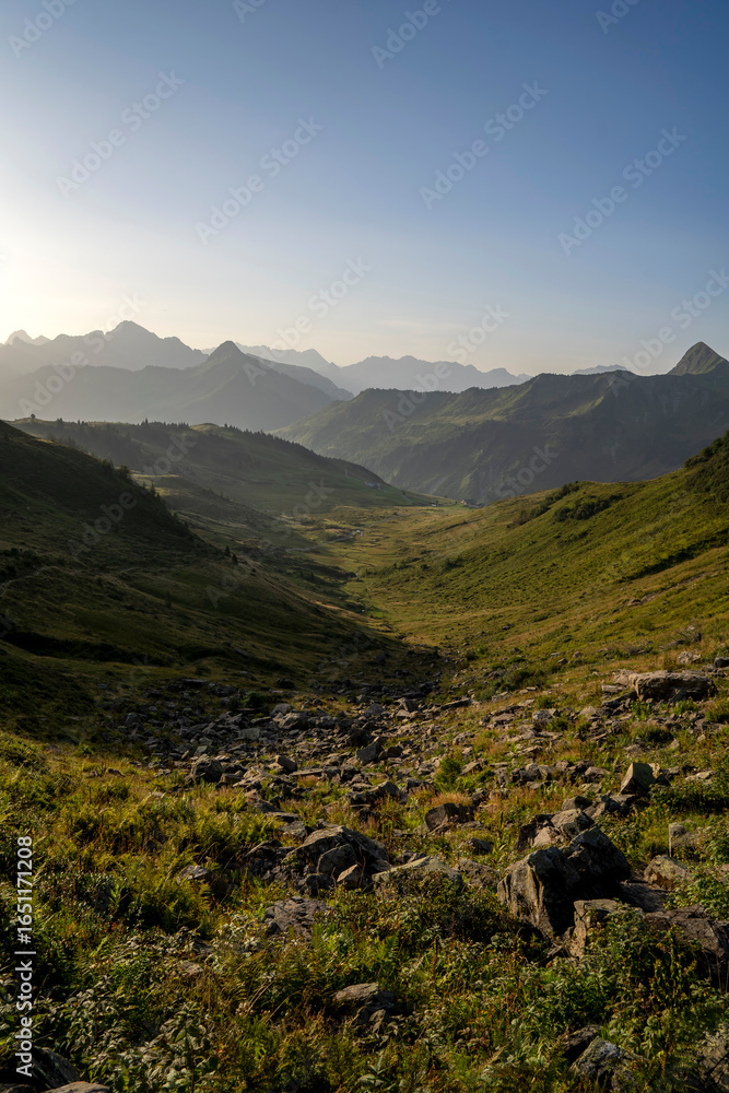 Obraz premium alpine landscape in early morning after sunrise with layers of mountains in the background in Damüls Bregenzer Wald in Vorarlberg Austria 