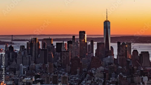 Aerial view of New York City during sunset with One World Trade Center and Manhattan Bridge in the backgroundskyscraper.