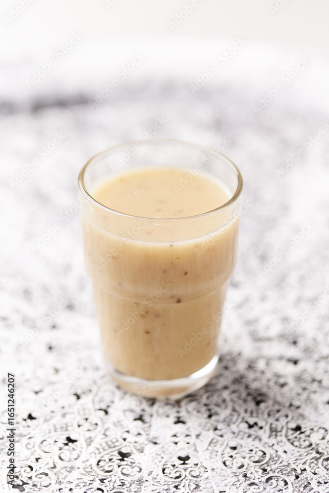Pineapple coconut smoothie on bright background. Soft focus. Copy space.