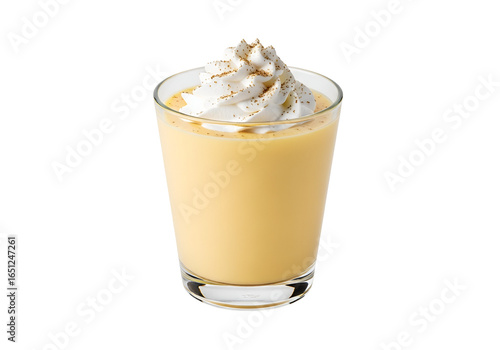 A glass tumbler filled with a smooth, creamy, light orange eggnog drink, topped with a fluffy dollop of whipped cream and a sprinkle of cinnamon.