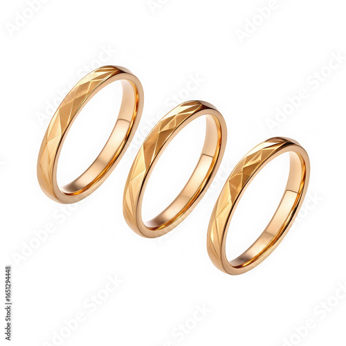 Three polished gold wedding bands isolated on transparent background. Diagonal arrangement of engraved gold rings. Lustrous metallic wedding bands with etched patterns.