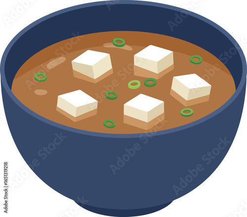A delicious bowl of traditional japanese miso soup with tofu cubes and green onions served in a dark blue bowl