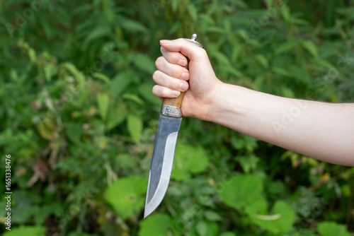 Fotografi A man with a knife in his hands. Aggression and death threats.