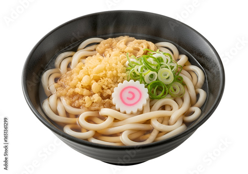 Traditional Japanese udon noodle soup with toppings including tempura and green onions in a black