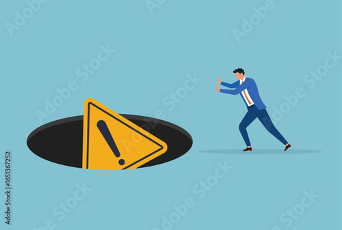 Vector illustration of a businessman pushing warning signs into a dark hole, symbolizing risk avoidance, ignoring dangers, and neglecting important warnings in business or personal decisions
