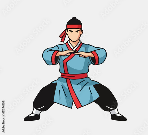 Martial Artist in Traditional Blue and Red Uniform Performing a Defensive Stance.
