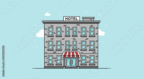 Classic Urban Hotel Building with Red Striped Awning and Numerous Windows.