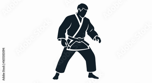 Silhouette of a martial artist in a traditional gi, ready for combat.