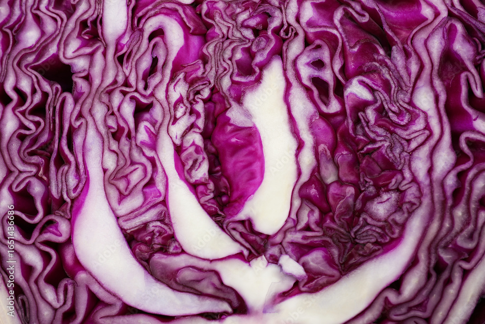Obraz premium Cut fresh red cabbage as background, closeup