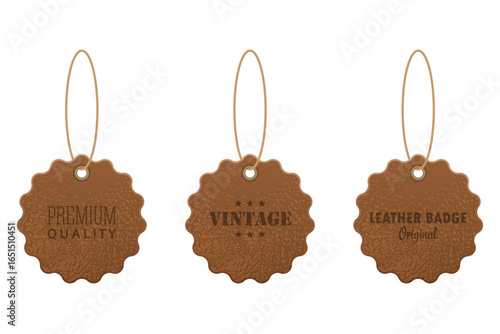 Three leather hang tags are displayed against a white background, each scalloped and suspended by a thin twine string, stamped with different labels.