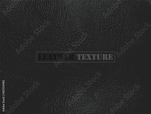 A detailed view of a dark, textured material fills the frame. The pattern creates an interesting visual effect with its uneven, granular composition and subtle light variations.