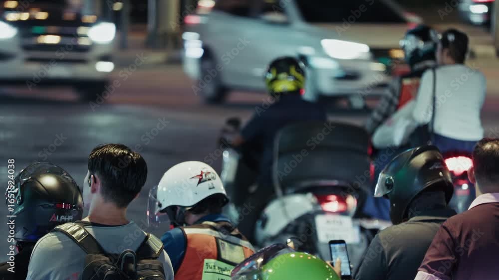 Motorcycle Intersection Nighttime urban traffic scene showcasing motorcyclists waiting at an ...