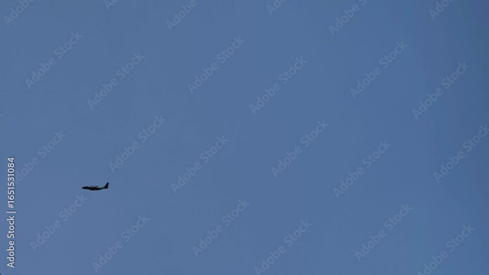 Airplane flying in clear blue sky, travel and aviation concept Airplane flying in clear blue sky, travel and aviation concept