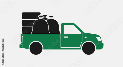 A green pickup truck loaded with stacked tires and black trash bags for junk removal.