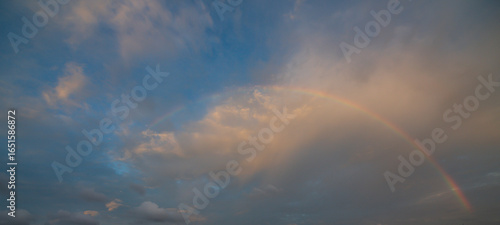 Fototapeta Naklejka Na Ścianę i Meble -  The sky with clouds and a beautiful rainbow