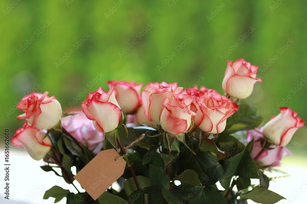 Fototapeta premium Rose Jumilia, bouquet of roses, pink rose flowers on the table, free space, top view