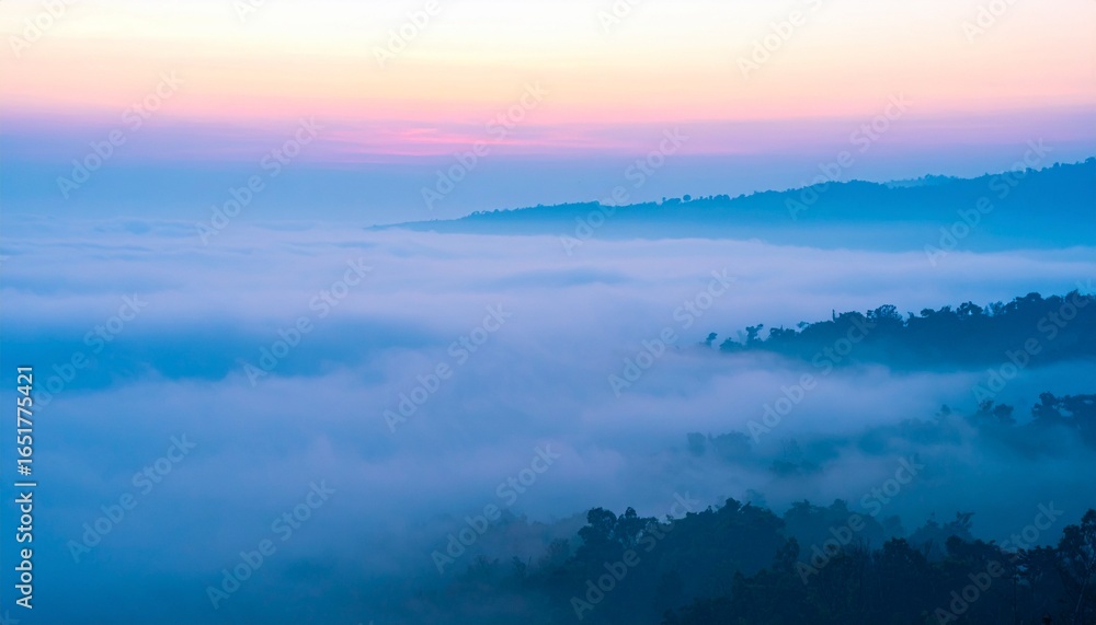 Fototapeta premium Dreamy pastel sunrise over misty mountain valleys creating a serene and tranquil landscape view