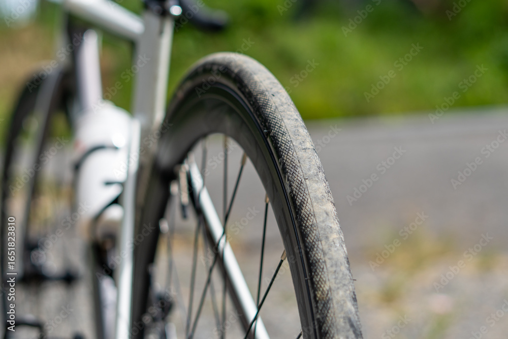 Fototapeta premium Bicycle tire with a white bottle on the handlebars