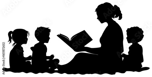 Silhouette of Teacher Reading Book to Young Children Sitting on Floor