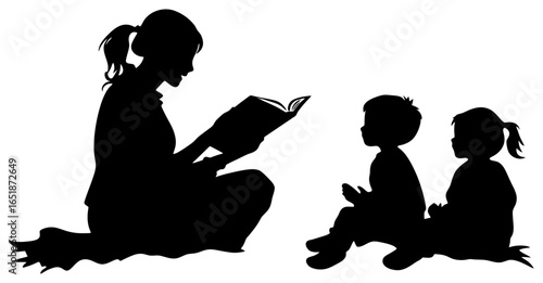 Silhouette of Teacher Reading Book to Young Children Sitting on Floor