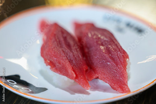 Fresh bluefin tuna nigiri on a plate at a sushi restaurant. Delicious raw fish over rice is healthy and tasty. 