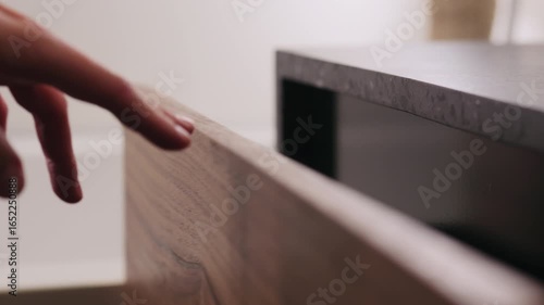 Slow motion man hand open and close batroom cabinet drawer closeup