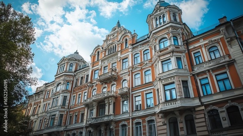 Ornate, multi-story building facade under a partly cloudy sky