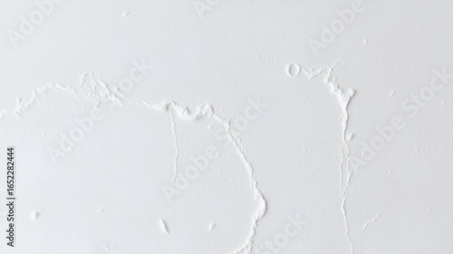 Close-up photo of a white putty textured wall. Textured Simplicity.