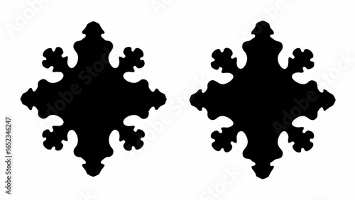 Two stylized black snowflake shapes symmetrically positioned against a white background isolated view