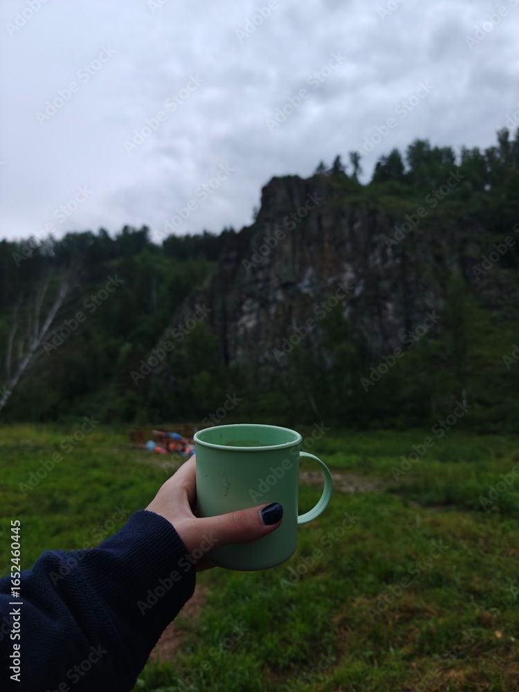 Obraz premium Morning Calm Cup of Tea in Nature with Mountain View, Refreshing Outdoor Moment. Serenity