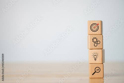 Wood cube block stacking with icon. business strategy and action plan Concept.